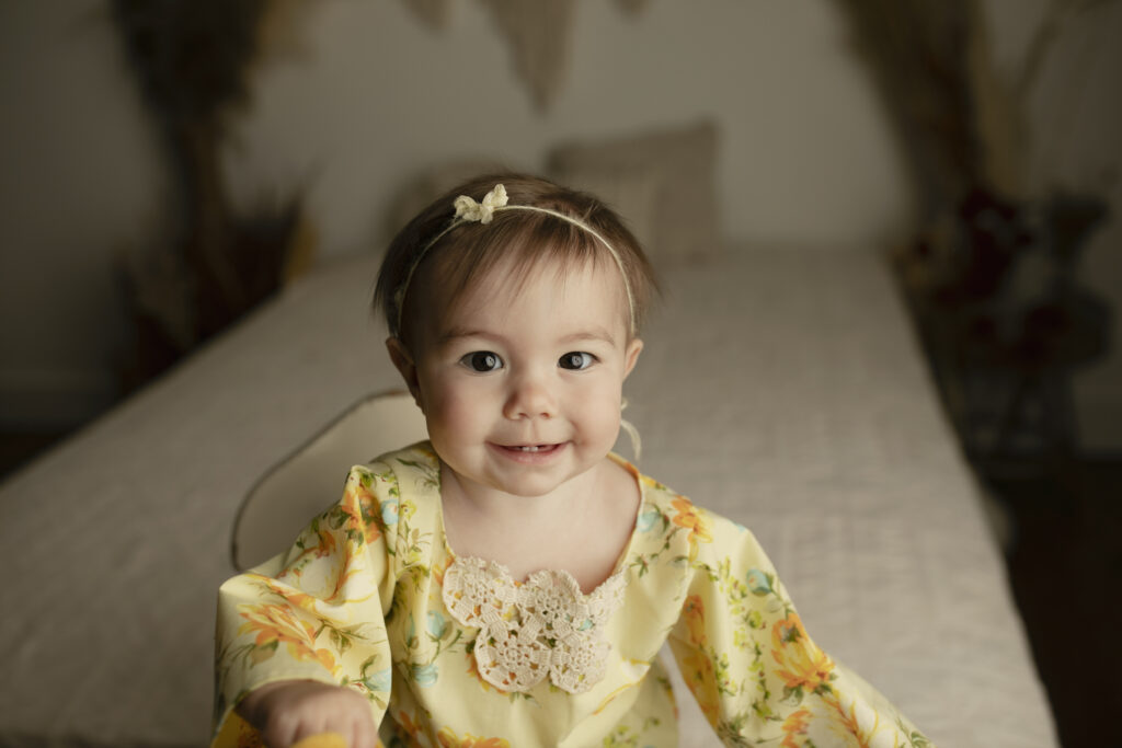 cute little girl in a yellow romper